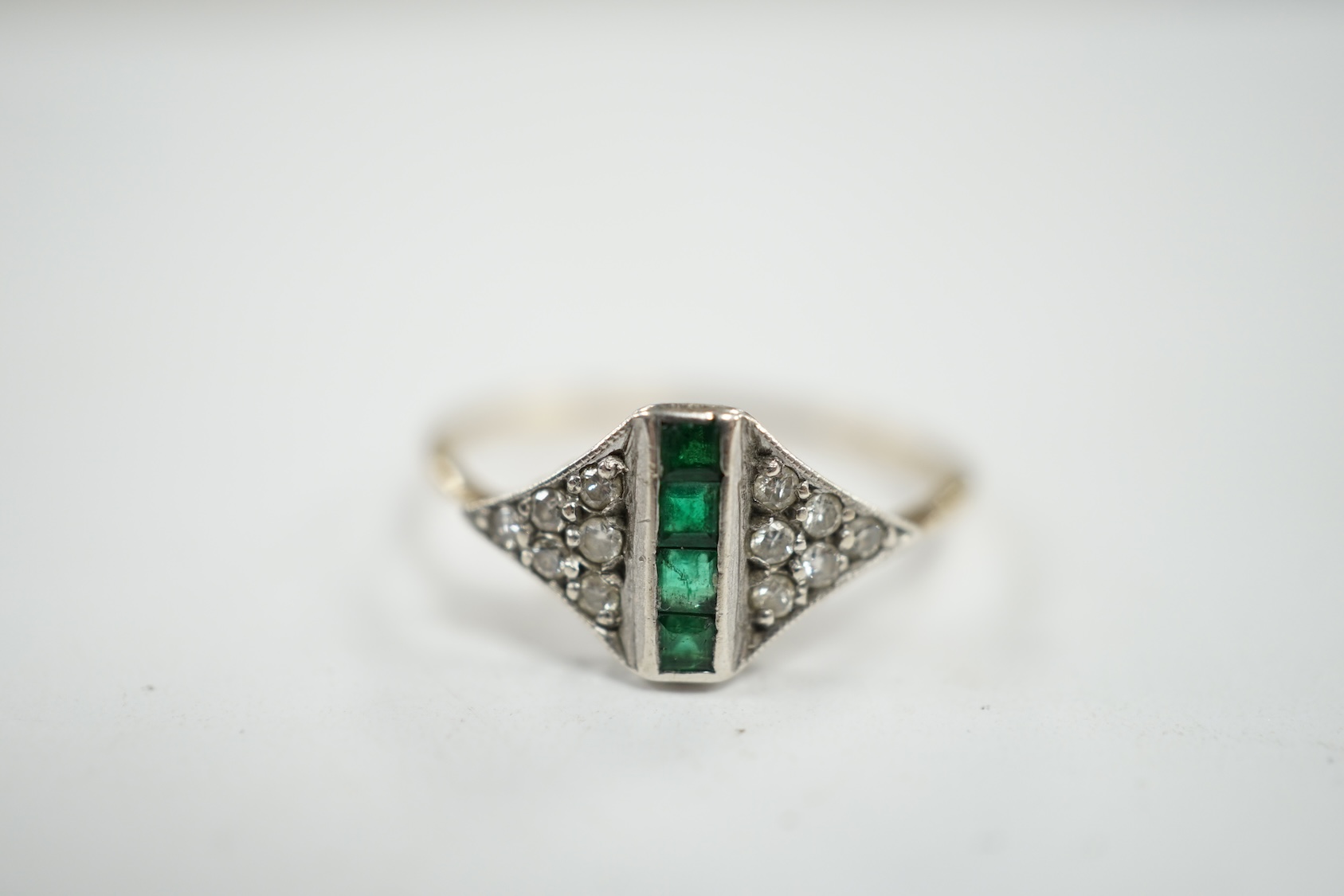 A small early 20th century 15ct, emerald and diamond cluster set ring, size P, gross weight 1.6 grams. Condition - fair